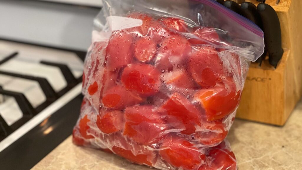 bag of cored tomatoes that had been previously frozen sitting on the counter