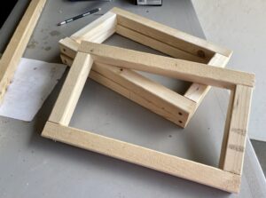 quail cage doors framed out and resting on a table