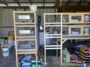 complete frame end of quail cage leaning up against a completed quail cage